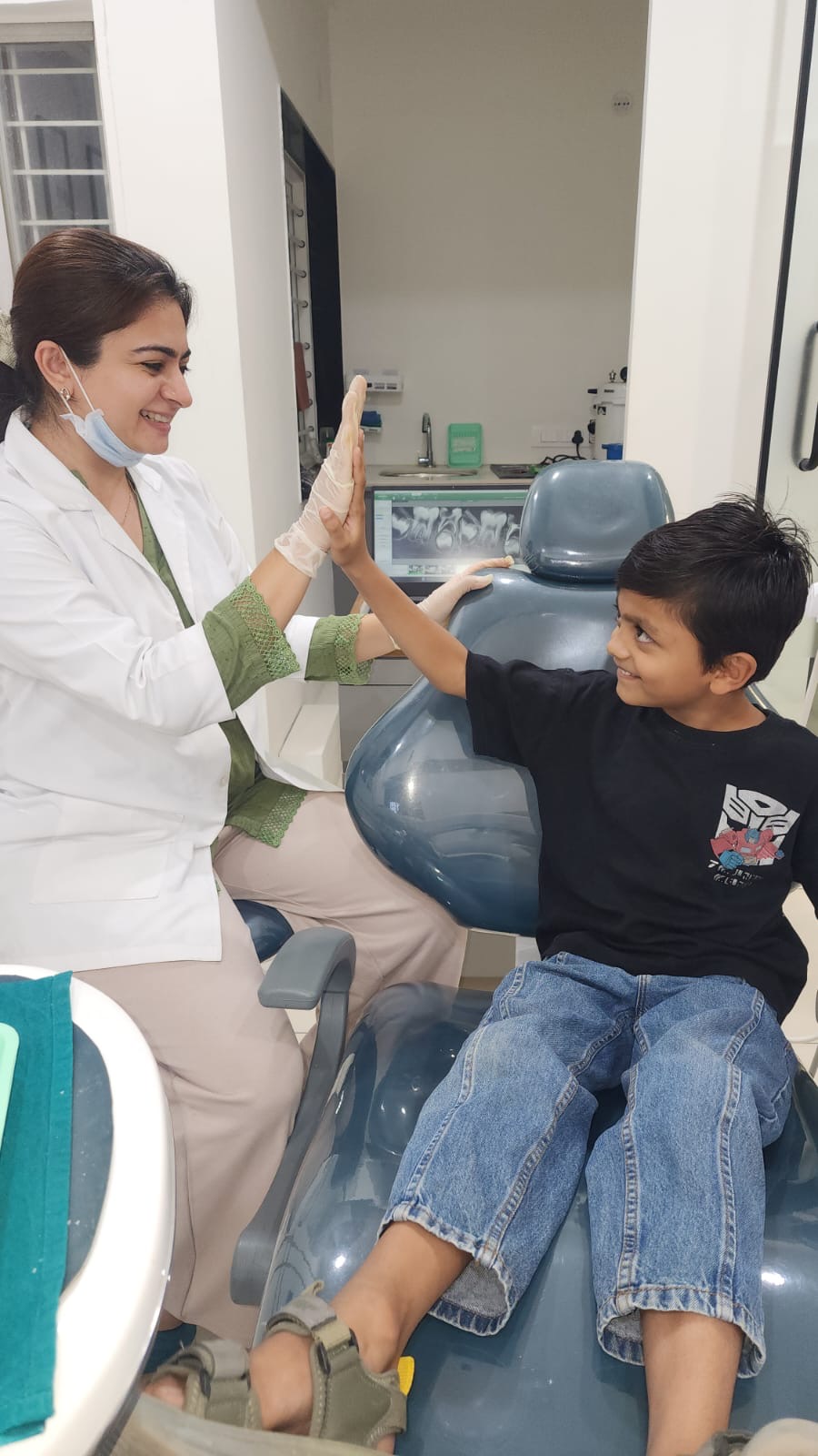 Young patient high-fiving the doctor